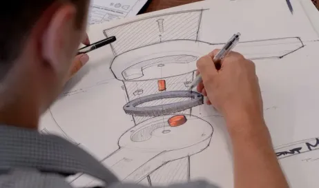 Designer sketching a product concept with marker on paper